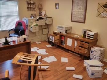 Picture of an office with papers on the floor